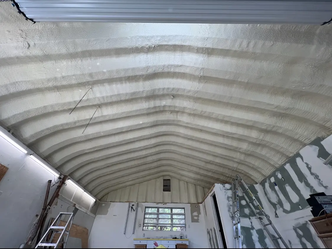 Spray polyurethane foam applied to the underside of a metal roof deck in North Brunswick